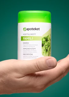 en hand som håller i ett kosttillskott från apoteket. 