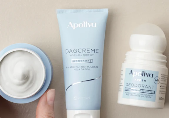 Apoliva dagkräm och roll-on deodorant; hand håller kräm.