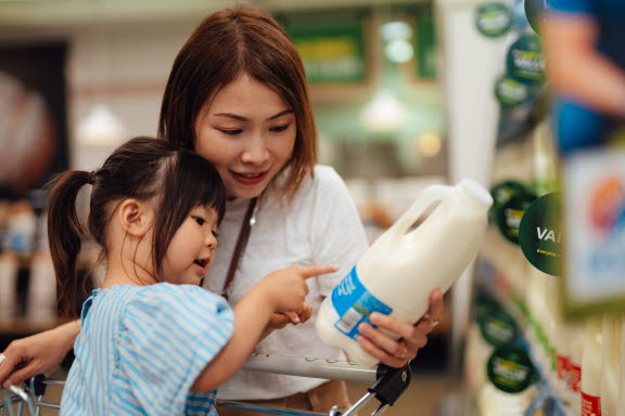 Mamma som läser innehållsförteckningen med sin dotter som har nötallergi.